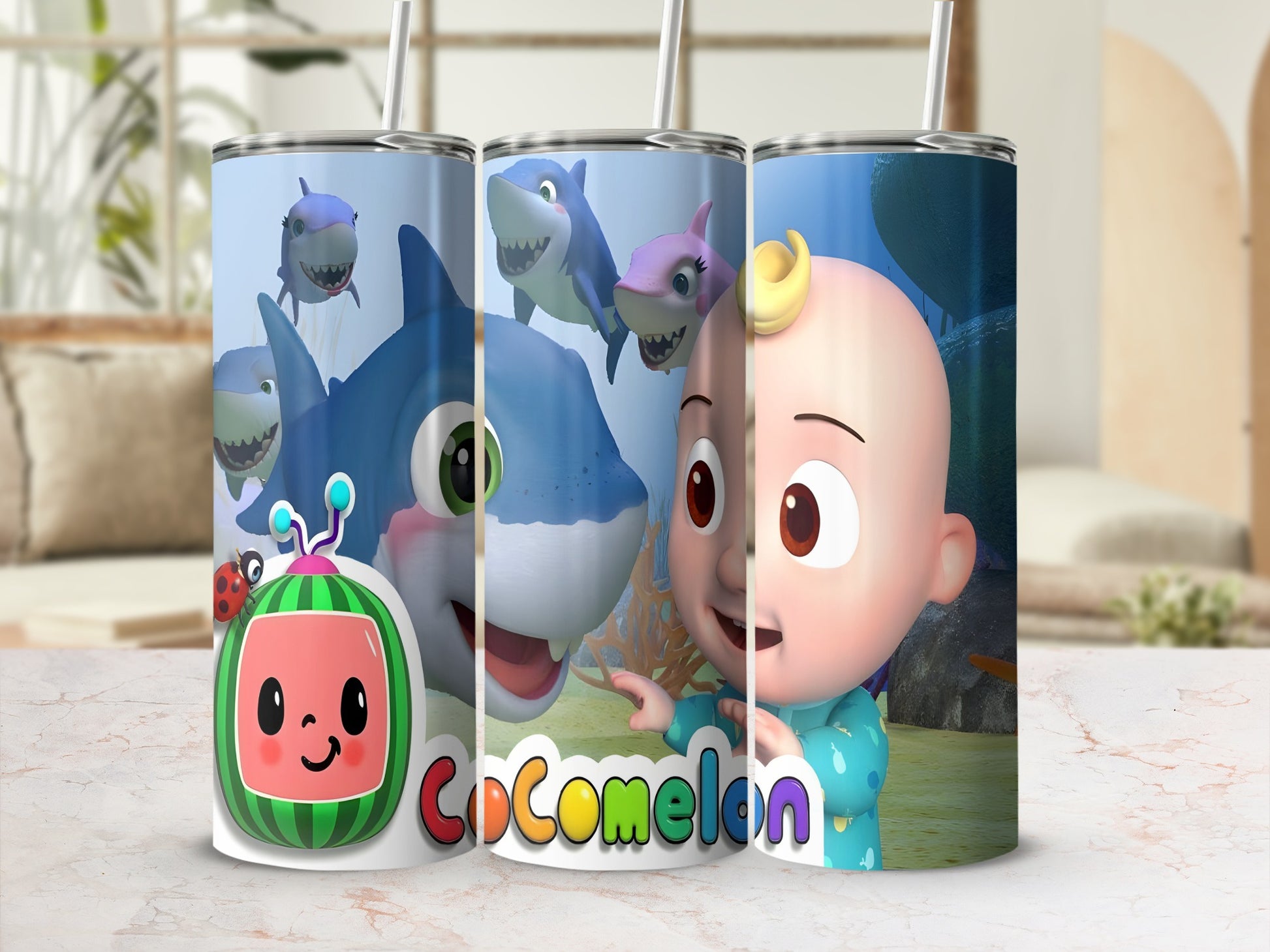 Cocomelon characters JJ and sharks on a patterned tumbler with straws.