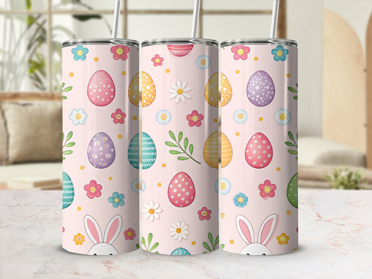 Pink tumblers with Easter eggs, daisies, and bunny ears.