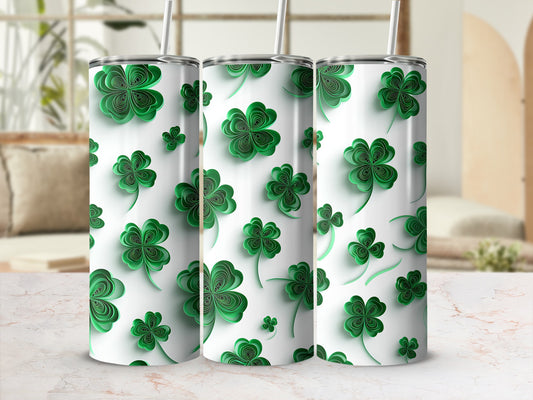 Three green clover pattern tumblers with straws on a marble surface.
