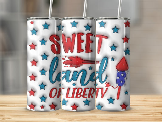 Red and blue "Sweet Land of Liberty" text with fireworks and stars on a tumbler.