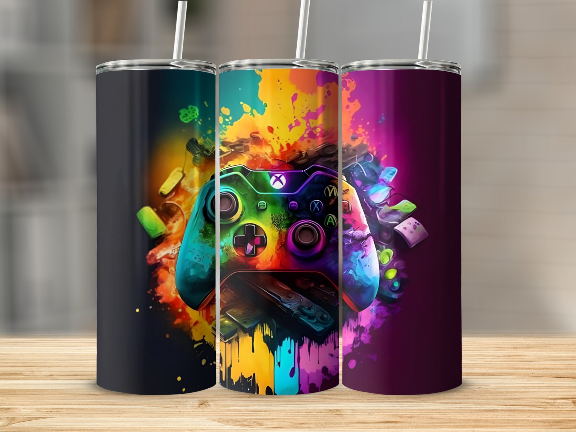 Three tumblers with colorful gaming controller graphics.