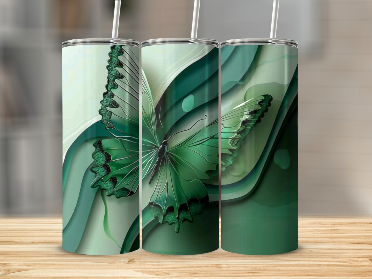 Green butterfly design on three tumblers with straws.