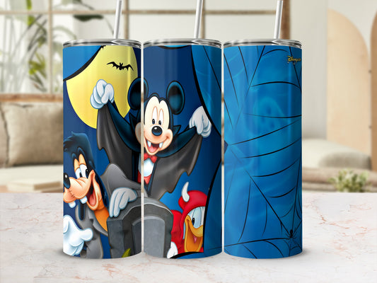 Mickey Mouse, Goofy, and Donald Duck in Halloween costumes on tumblers.