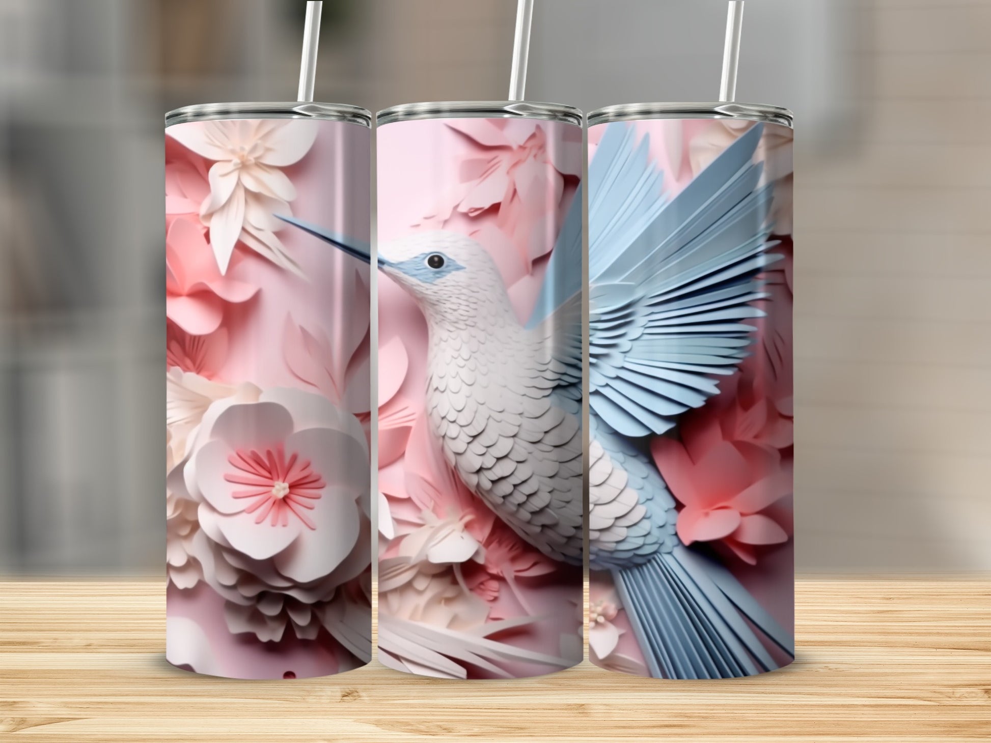 Three pink tumblers with a detailed blue and white hummingbird and floral design.