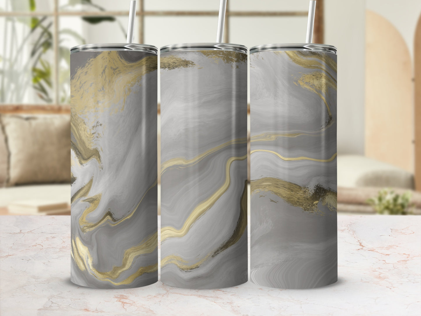 Three tumblers with a marbled gray and gold abstract design.