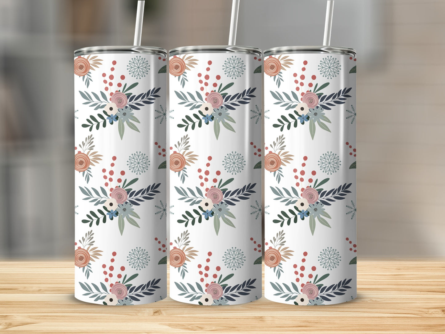 Three tumblers with a floral pattern sit on a wooden surface.