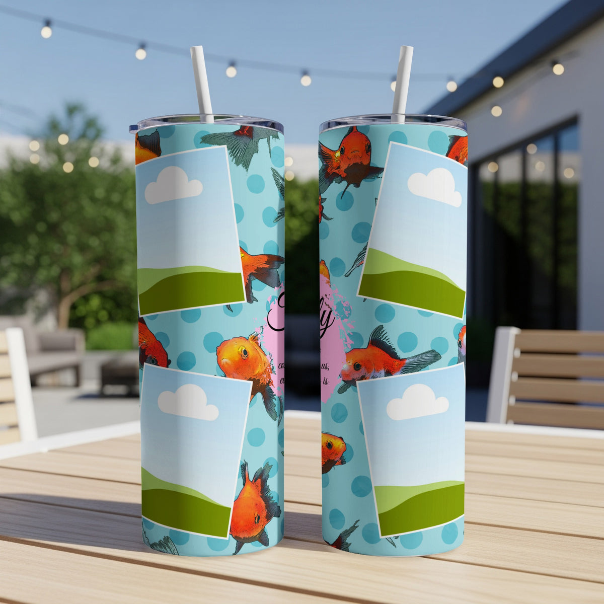 Two tumblers with a blue polka dot pattern, goldfish, and picture frames.