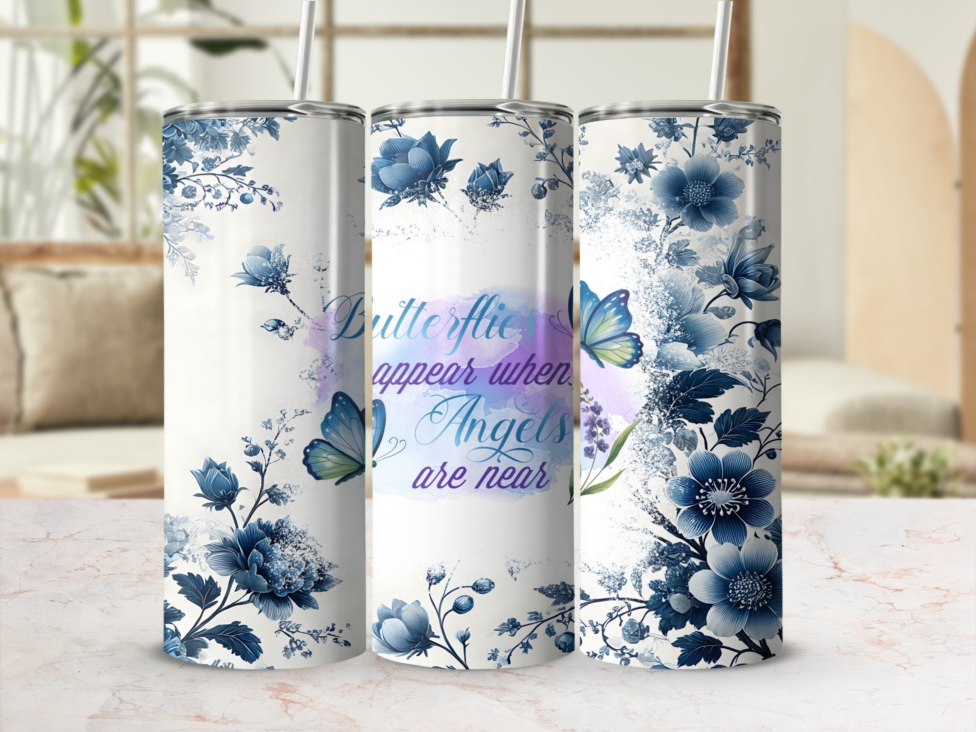 Tumbler with blue floral design and "Butterflies appear when Angels are near" text.