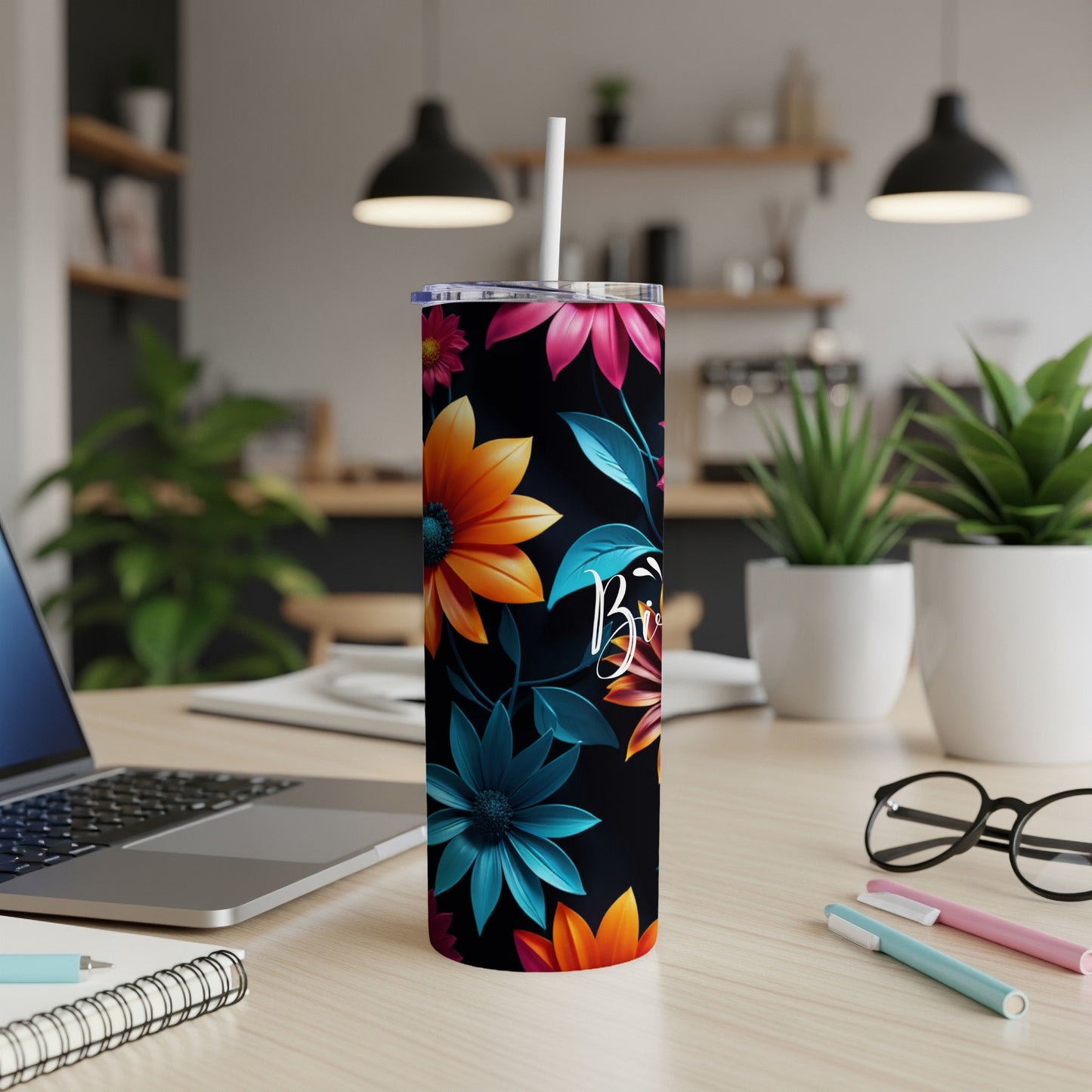Black tumbler with vibrant floral pattern and "Brie" text.