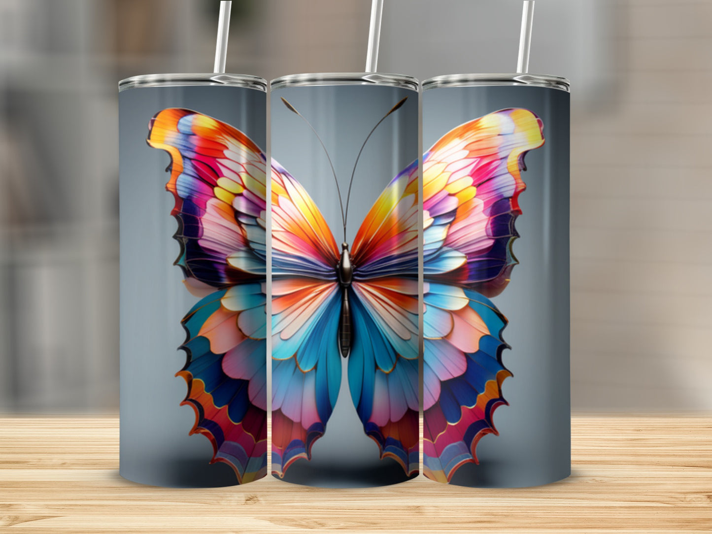 Colorful butterfly on a gray background, shown on three tumblers.