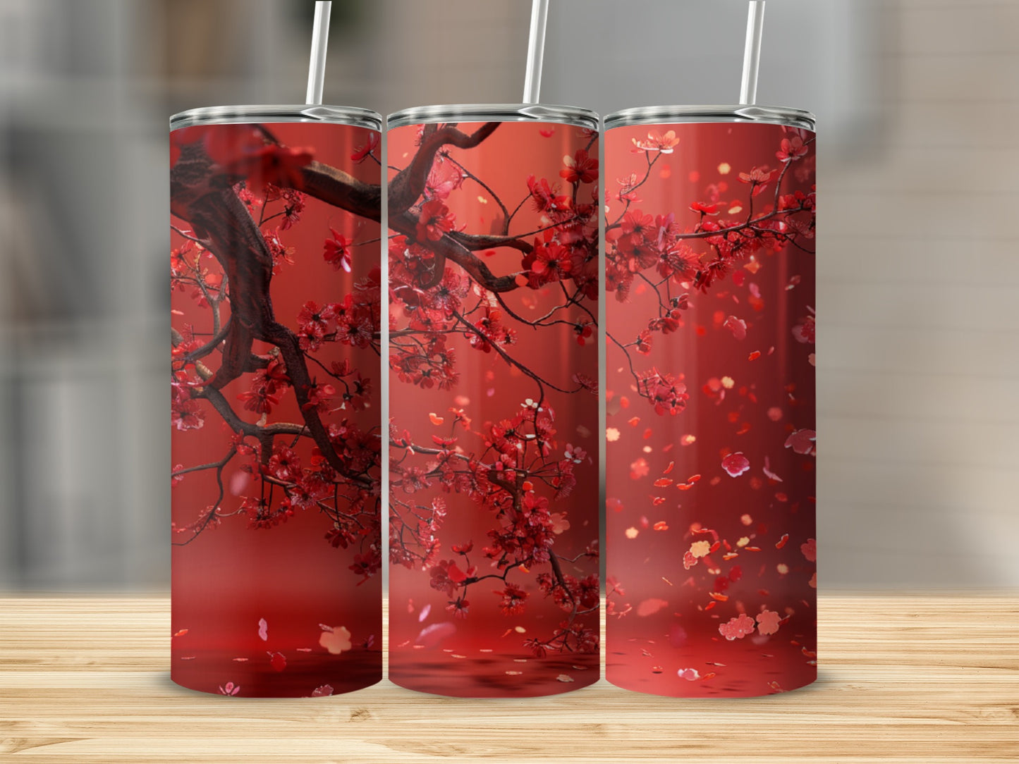 Three tumblers with blooming red cherry blossoms and falling petals.