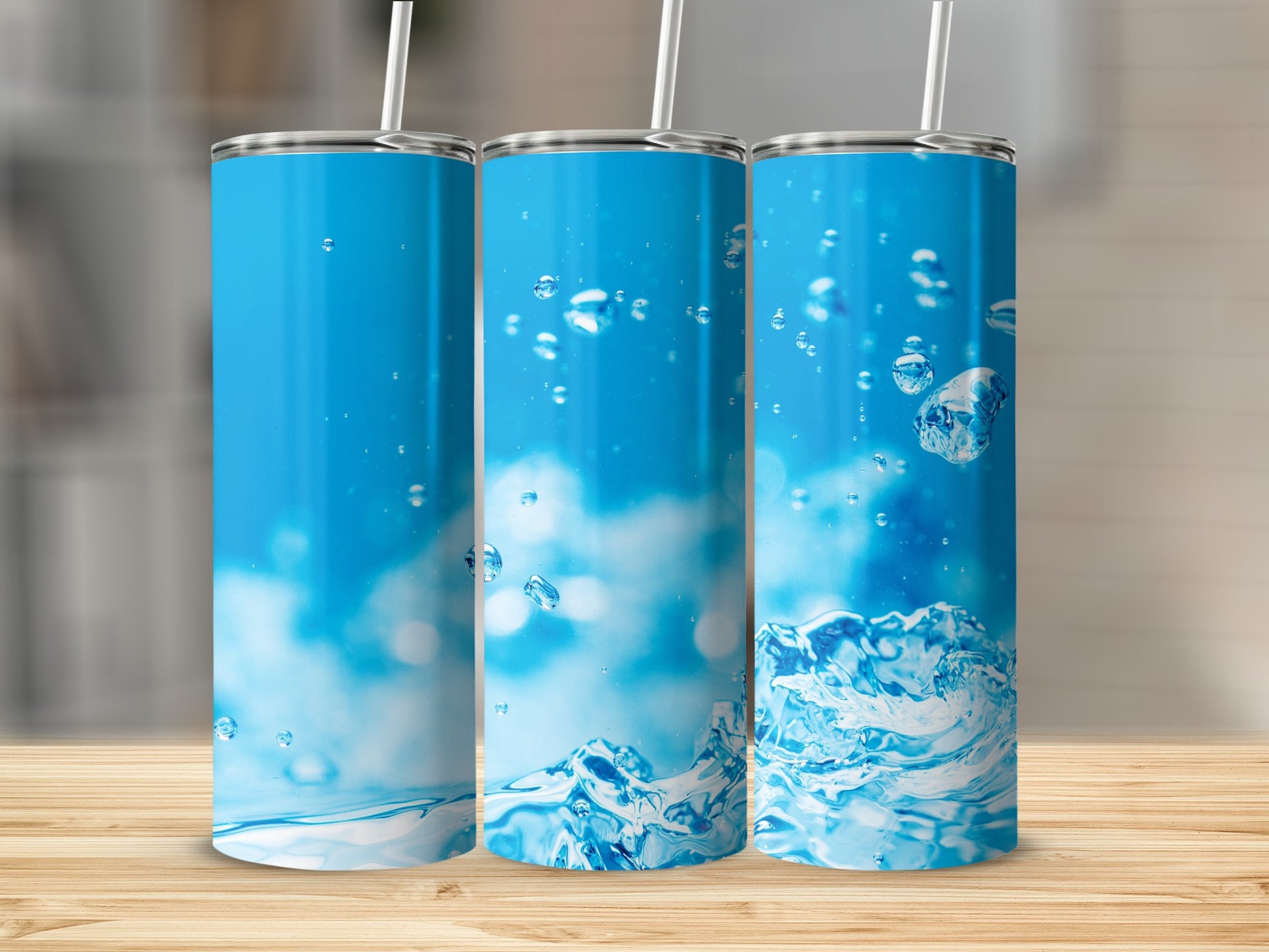 Three tumblers with a blue water splash and bubble design.