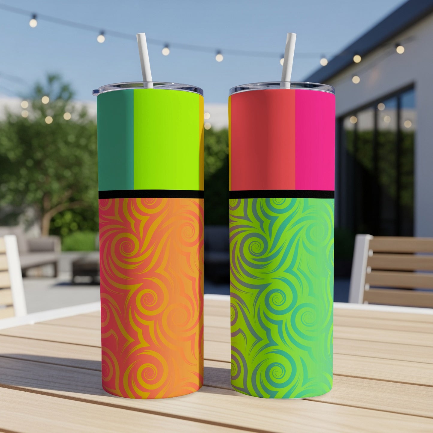 Two tumblers with colorful geometric and swirl patterns on a wooden table.