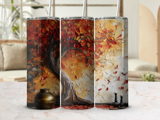 Three tumblers with vibrant autumn tree artwork and fallen leaves.