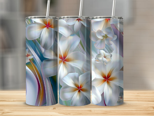 Three tumblers with a white floral design and straw on a wooden surface.