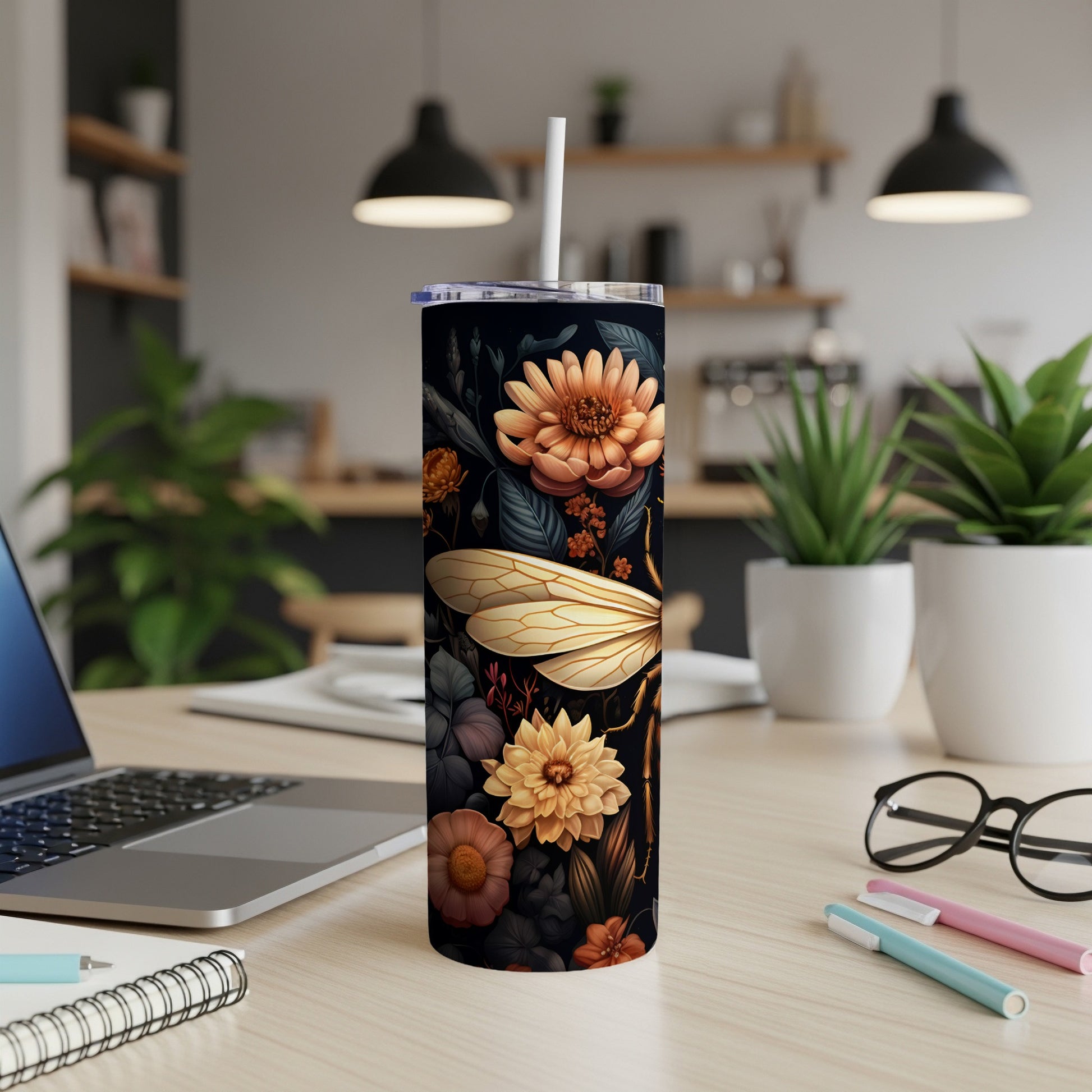 Dark tumbler with dragonfly and floral pattern, white straw.