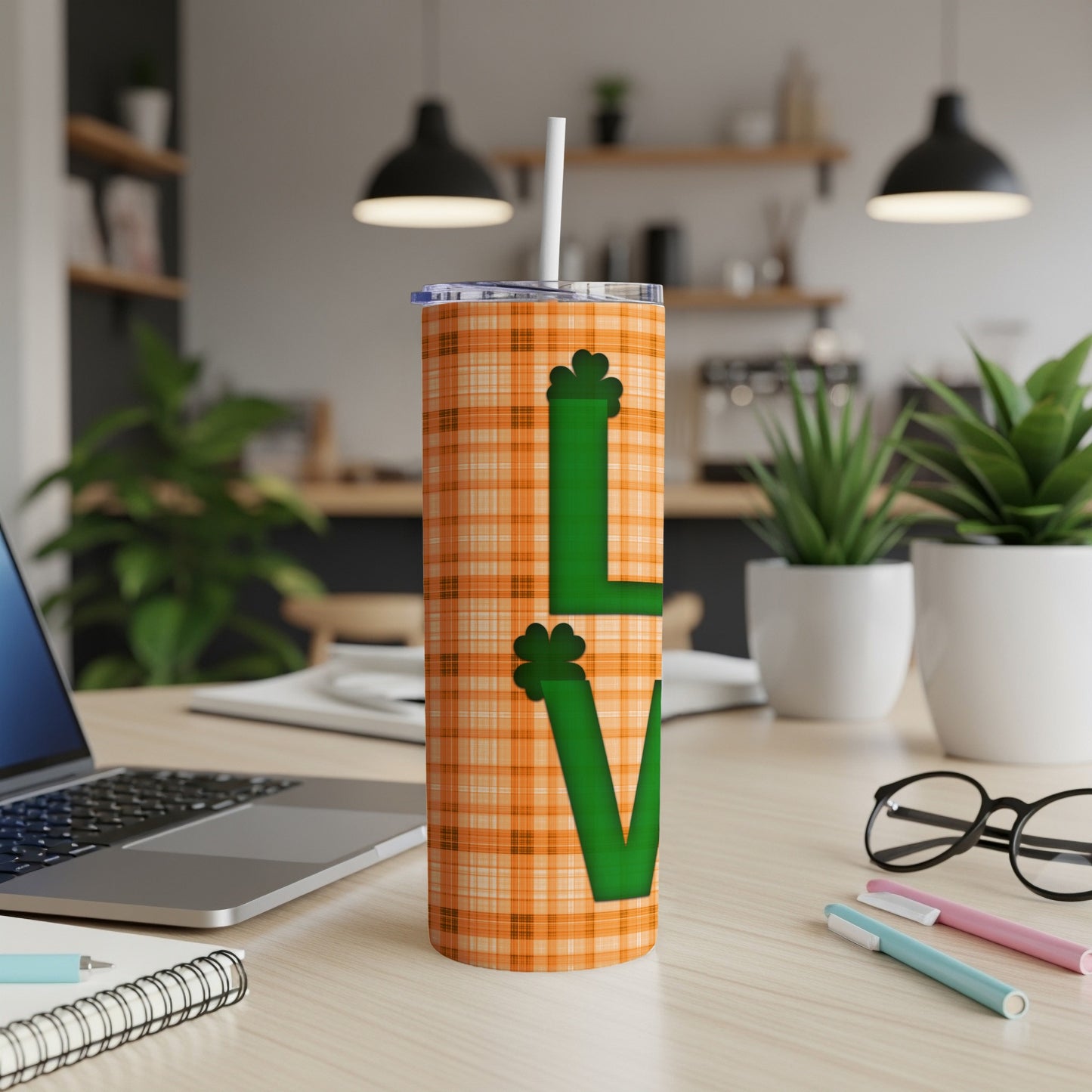 Orange plaid tumbler with green "LOVE" text and shamrocks.