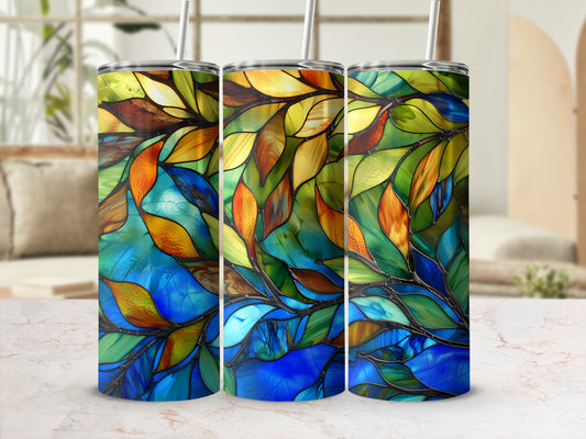 Three stained glass tumblers with colorful abstract leaf patterns.