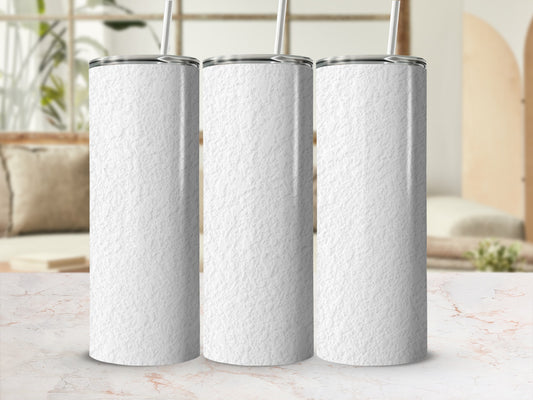 Three white textured tumblers with straws on a marble surface.