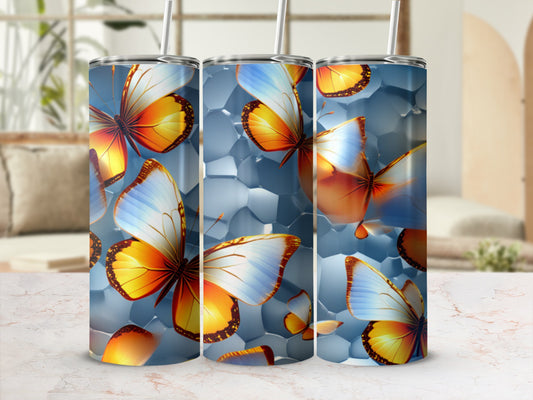 Three tumblers with a colorful butterfly design on a marbled surface.