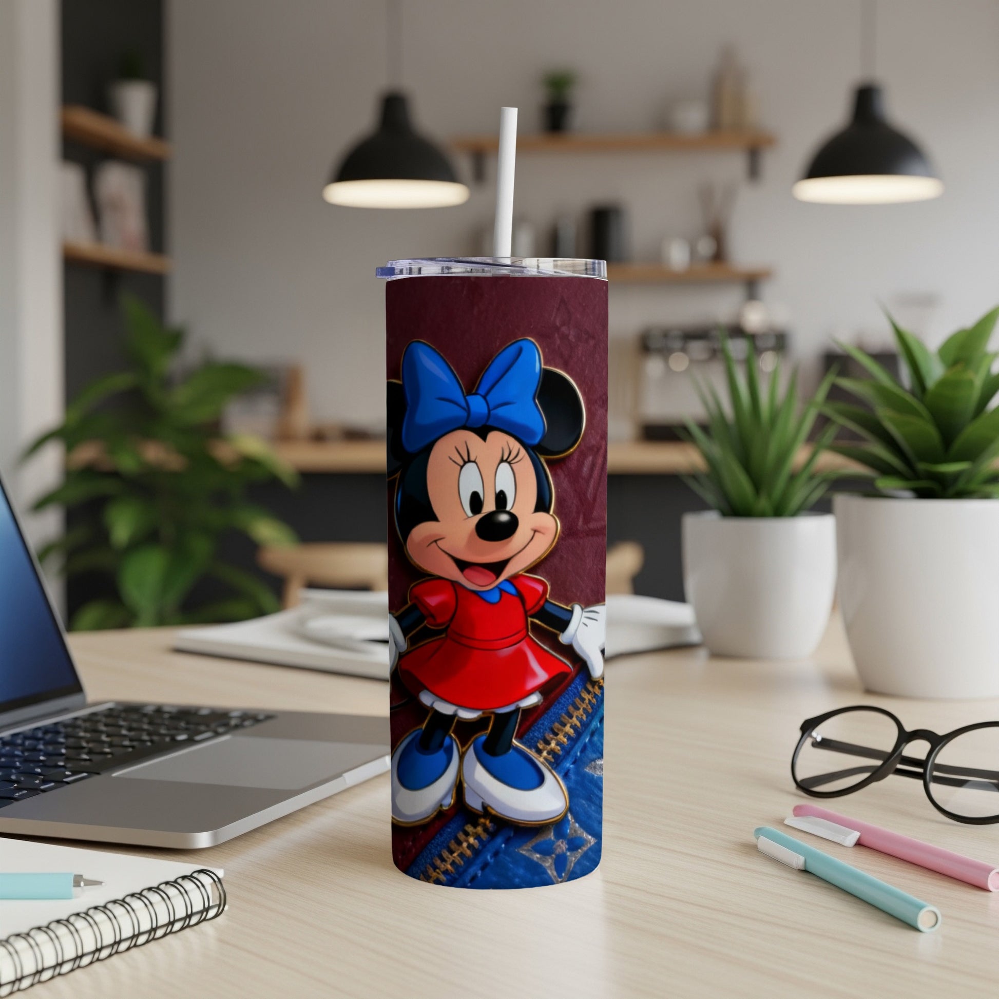 Minnie Mouse on a maroon tumbler with blue accents and a straw.