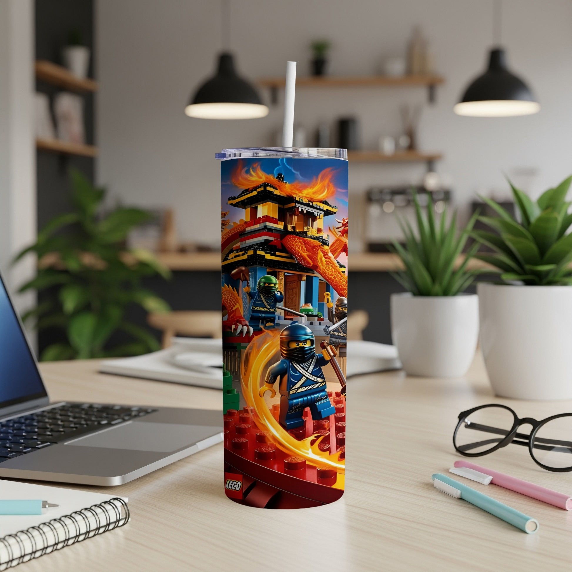 Ninjago LEGO characters with dragons and flames on a blue tumbler.
