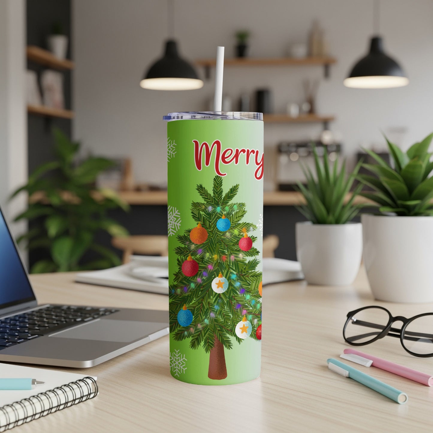 Green tumbler with "Merry" and decorated Christmas tree.