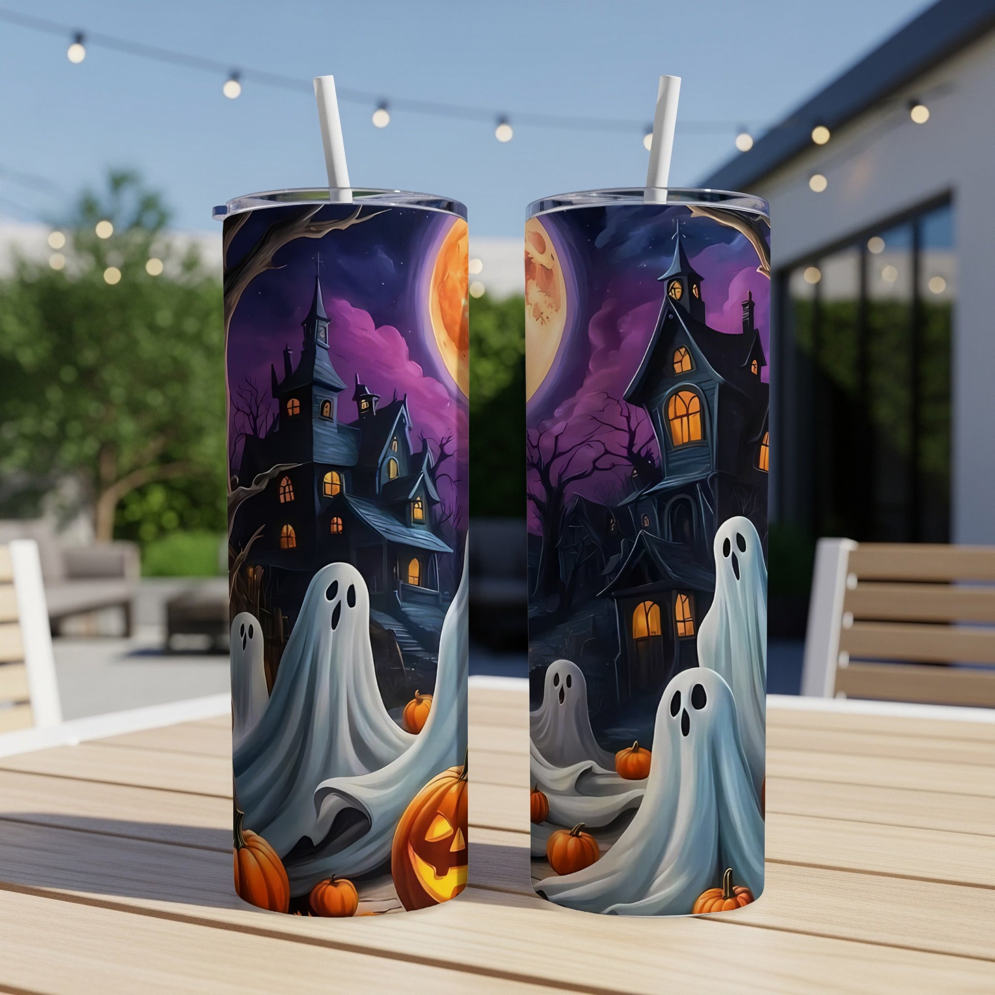 Halloween tumblers with haunted houses, ghosts, and jack-o'-lanterns against a moonlit sky.