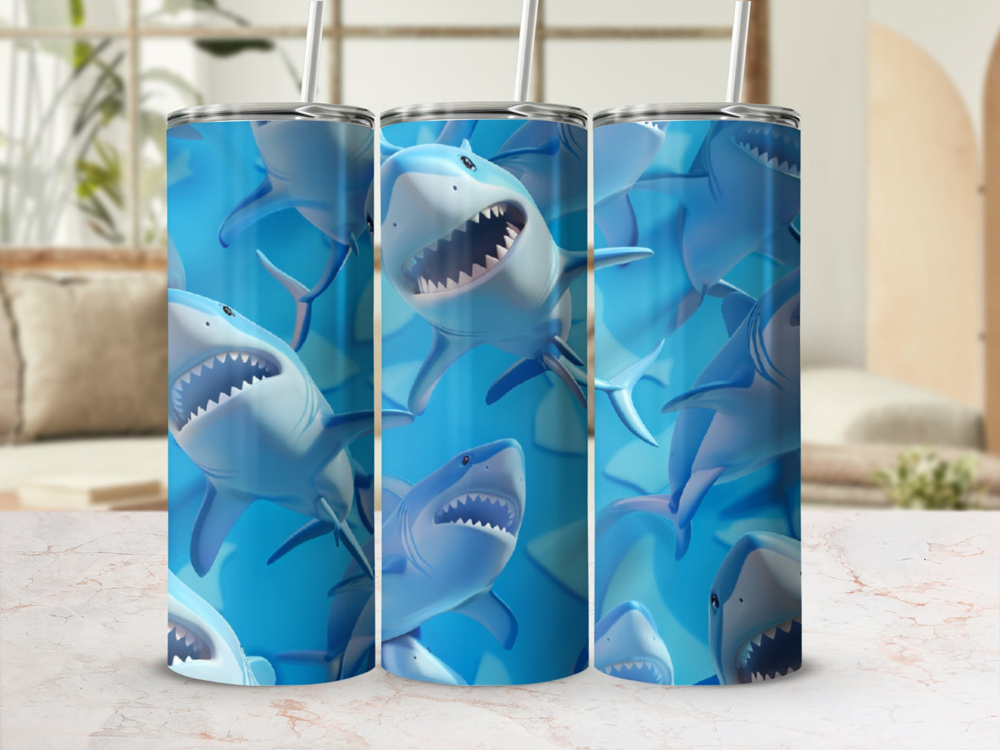 Three tumblers with a repeating pattern of cartoonish blue sharks.