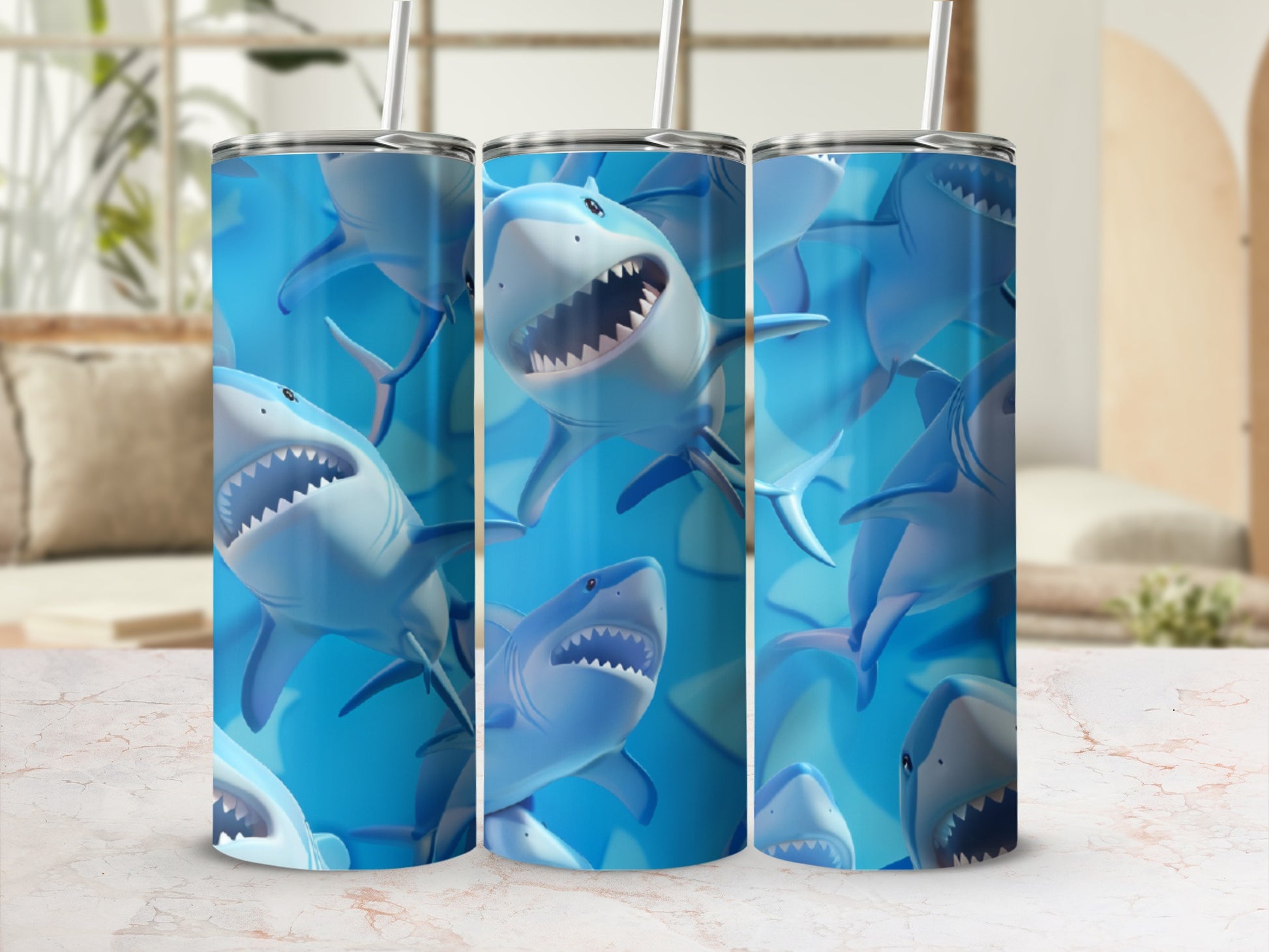 Three tumblers with a repeating pattern of cartoonish blue sharks.
