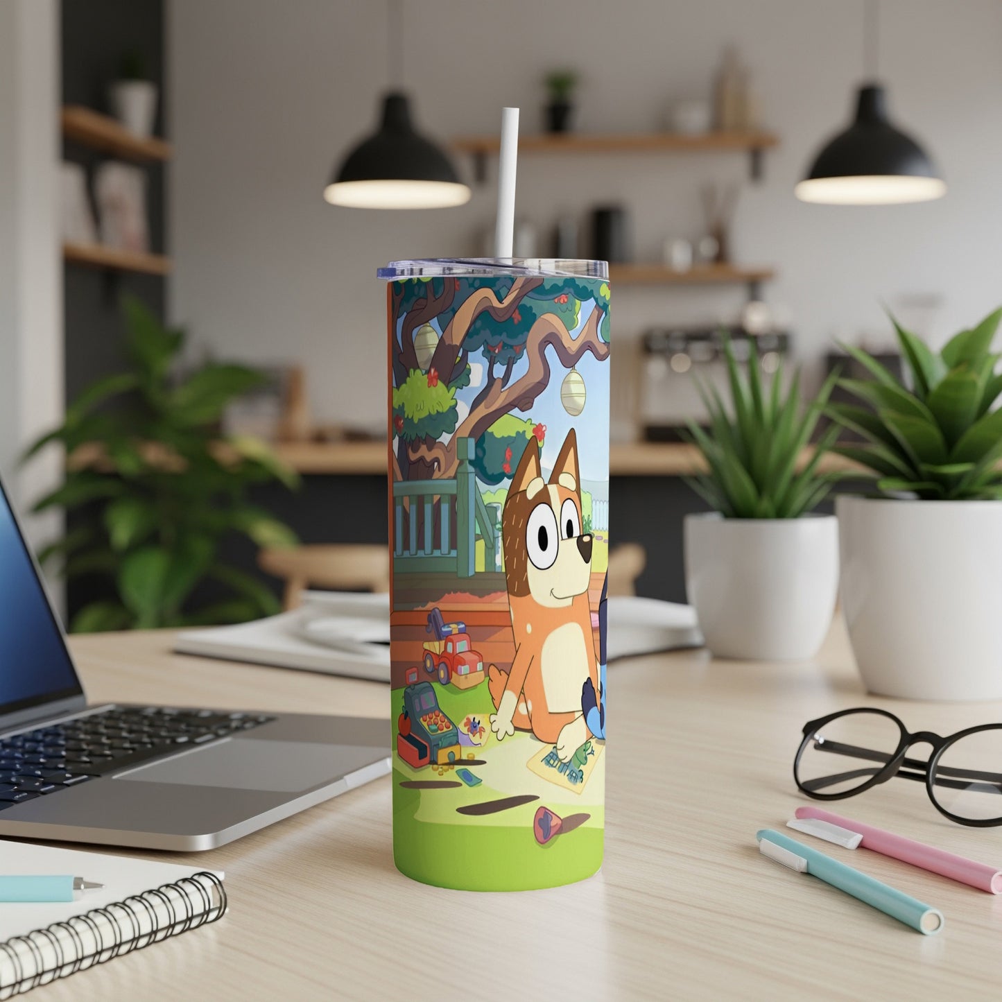 Bluey character cartoon artwork on a travel tumbler with straws and pens.