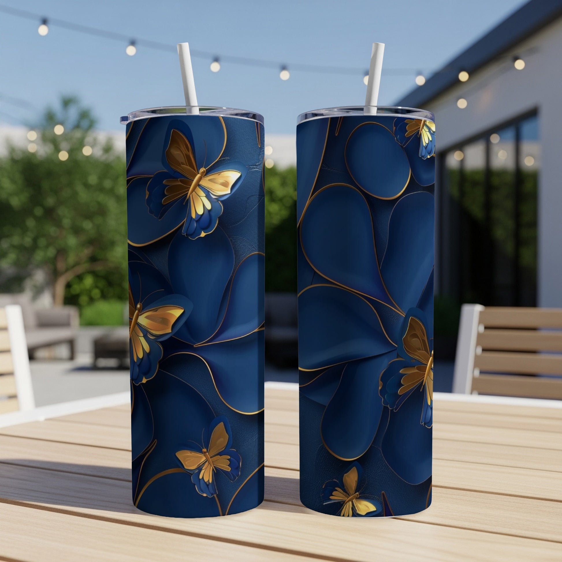 Two navy blue tumblers with gold butterfly and floral patterns.