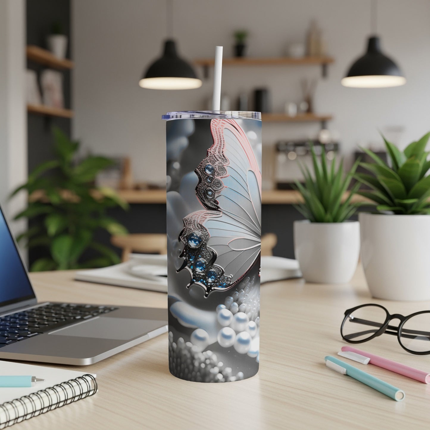 Butterfly design on a tall, slender insulated tumbler with a straw.