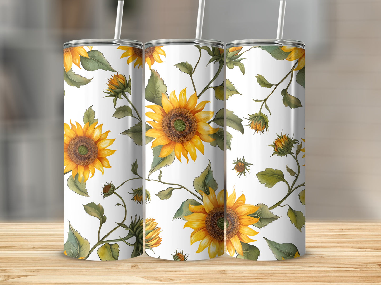 Three tumblers with a sunflower and vine pattern on a wooden surface.