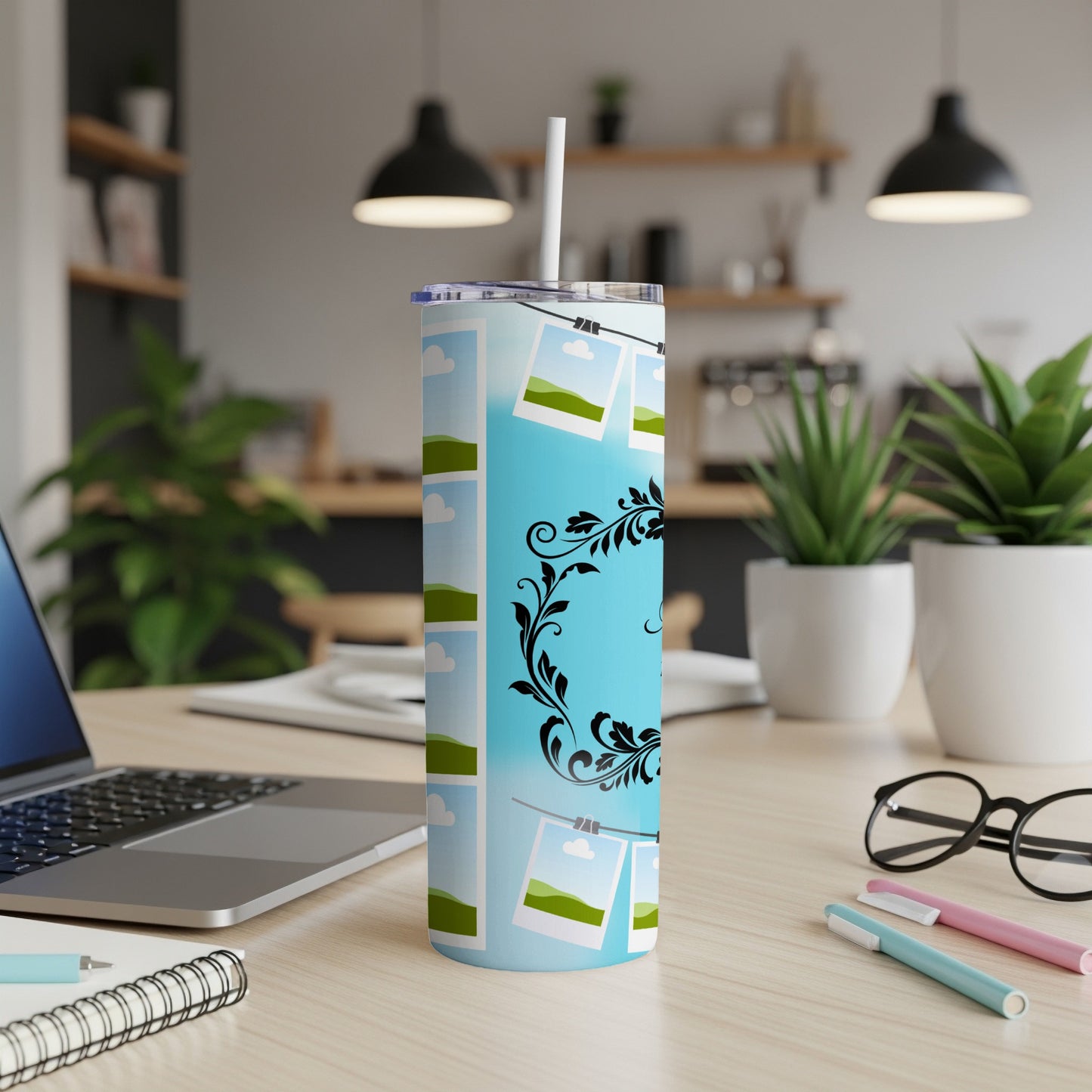 Blue tumbler with a sky and cloud pattern, featuring hanging photo frames and floral accents.