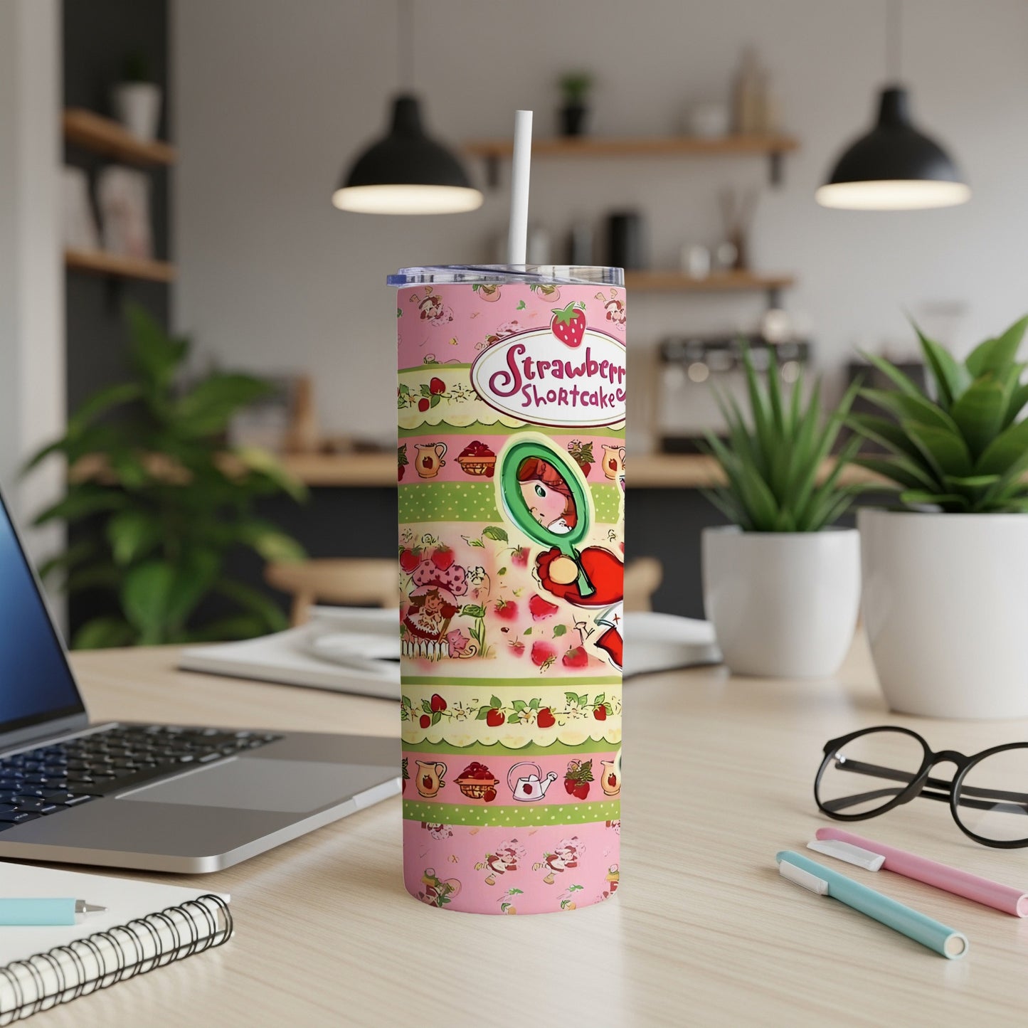 Strawberry Shortcake tumbler with pink, green, and yellow stripes and cheerful characters.