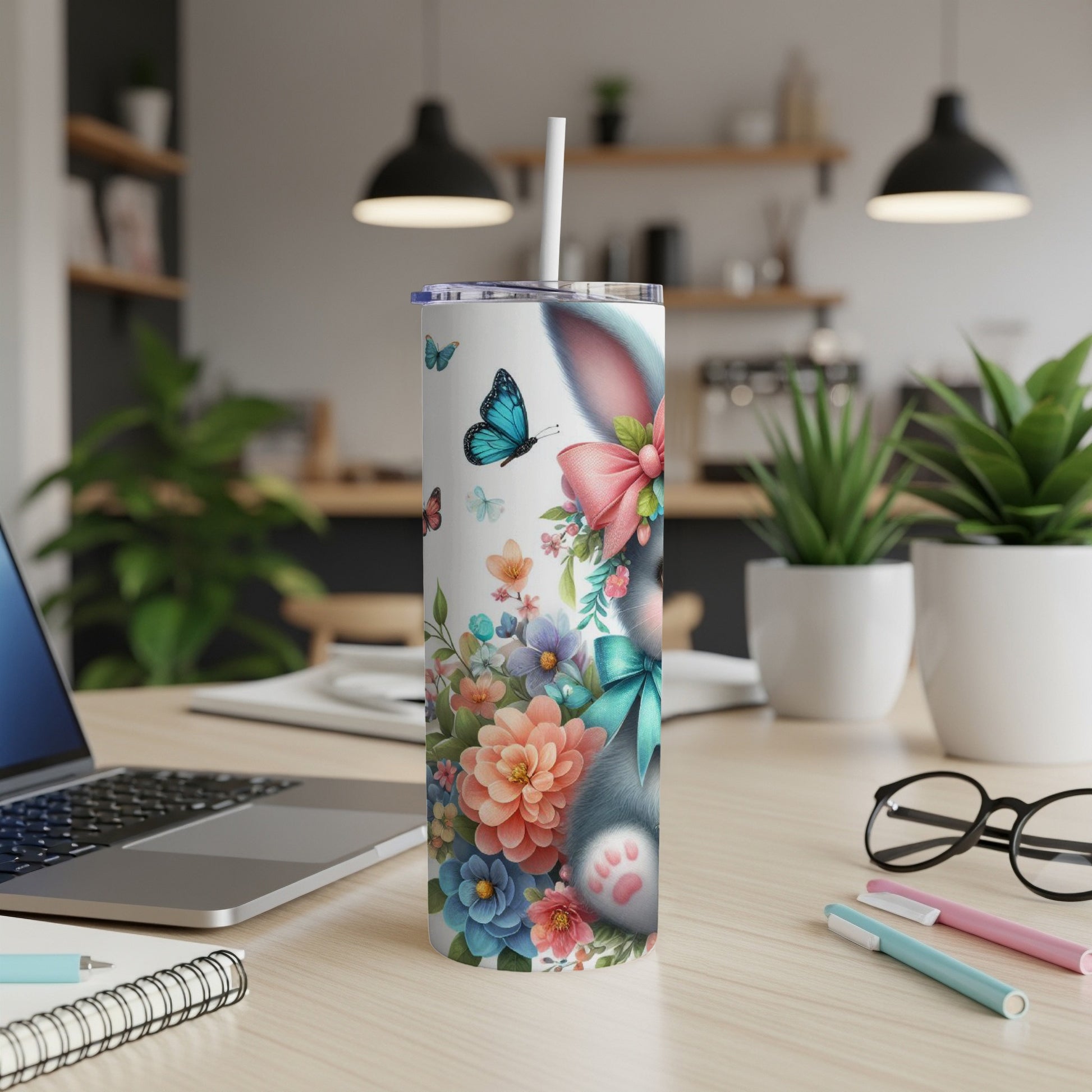 Tumbler with a floral design featuring a bunny and butterflies.