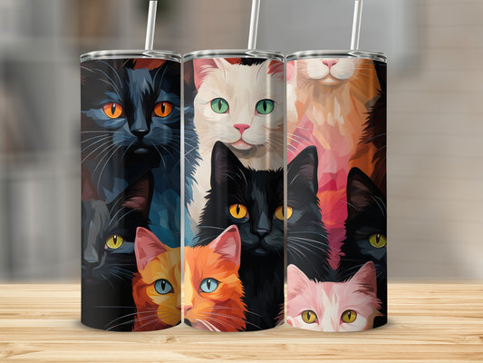 Three tall tumblers with colorful cat faces on a wooden surface.