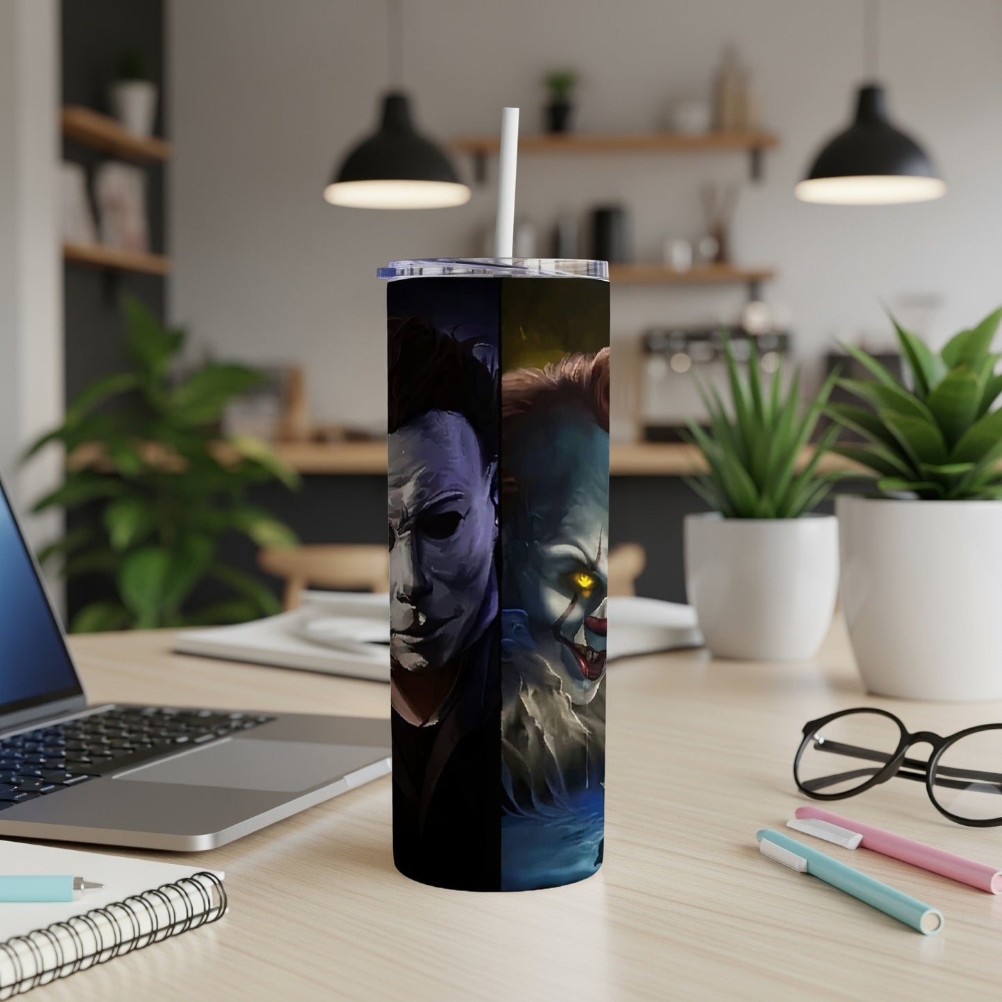 Tumbler featuring Michael Myers and Pennywise horror characters on a desk.