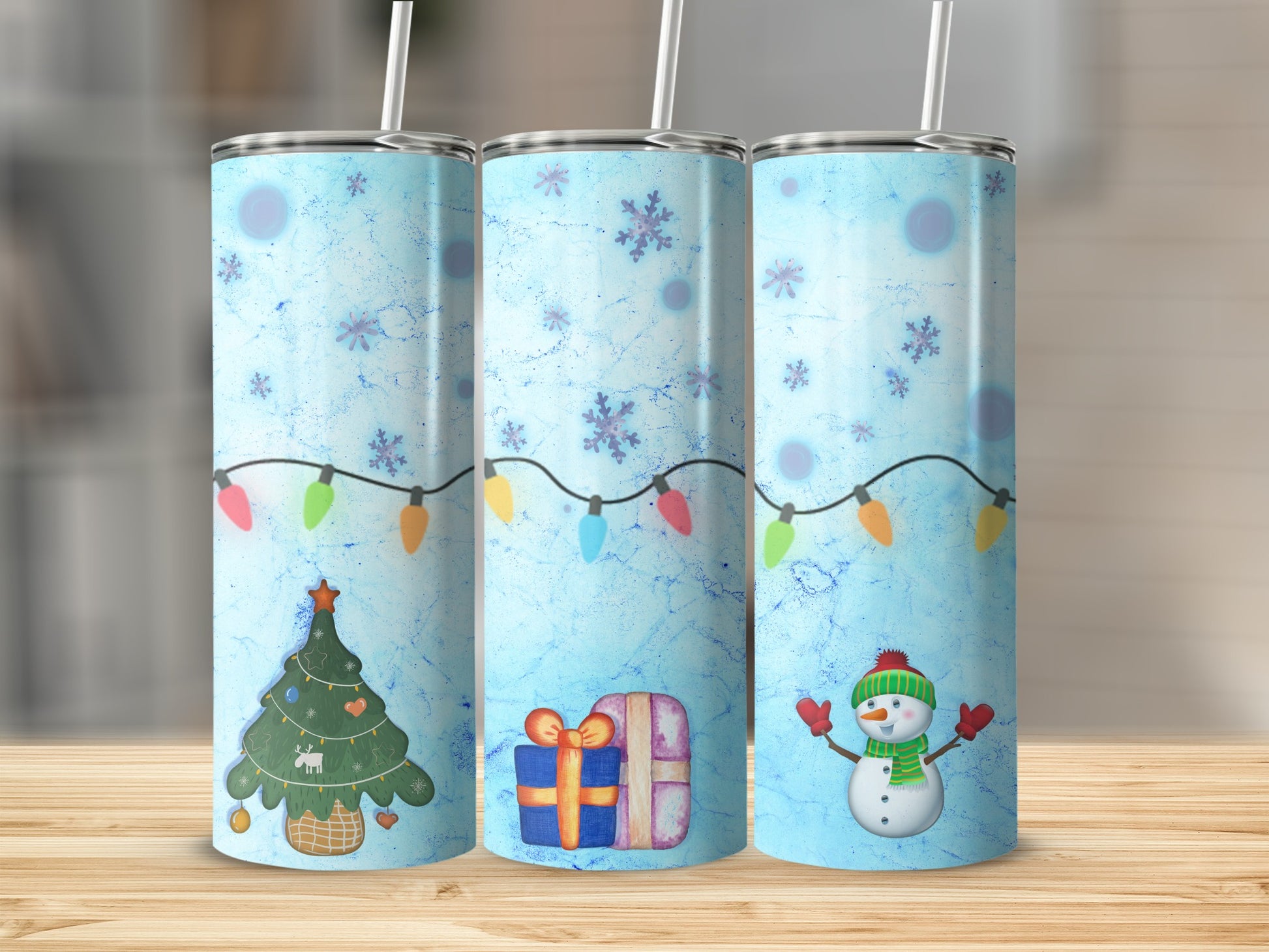 Blue tumbler with Christmas tree, gift, and snowman design.
