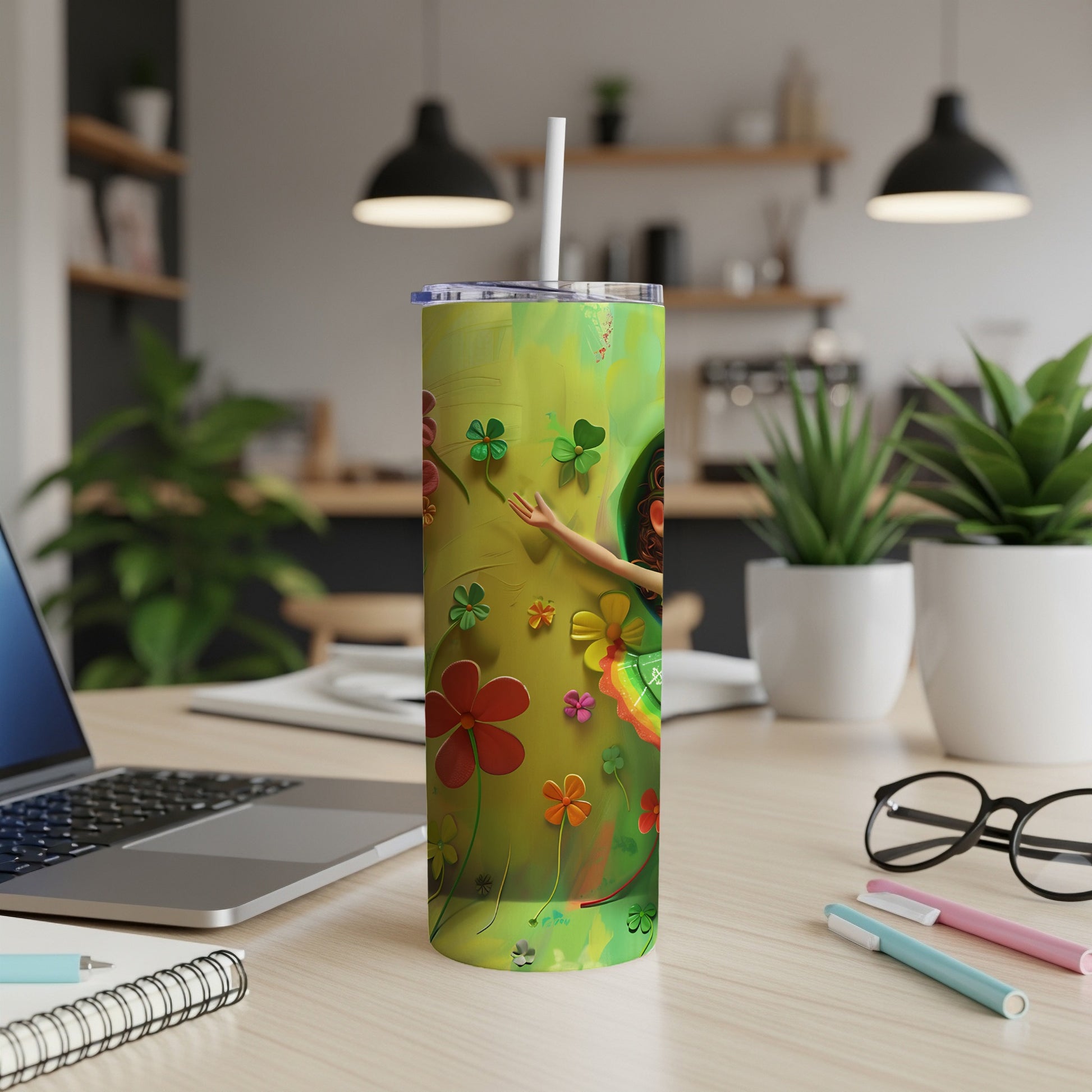 Green tumbler with colorful flowers and clover designs.