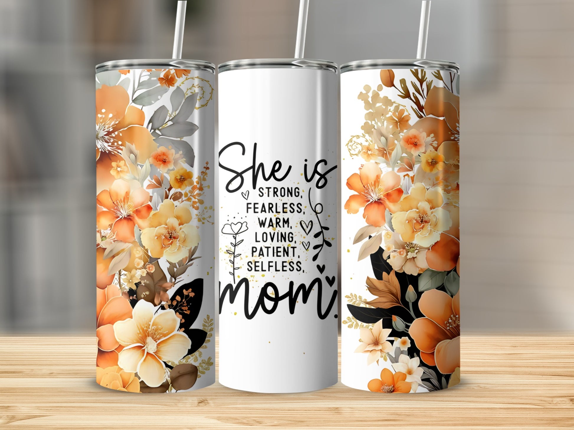 White tumbler with "She is strong, fearless, warm, loving, patient, selfless, mom" text and floral accents.
