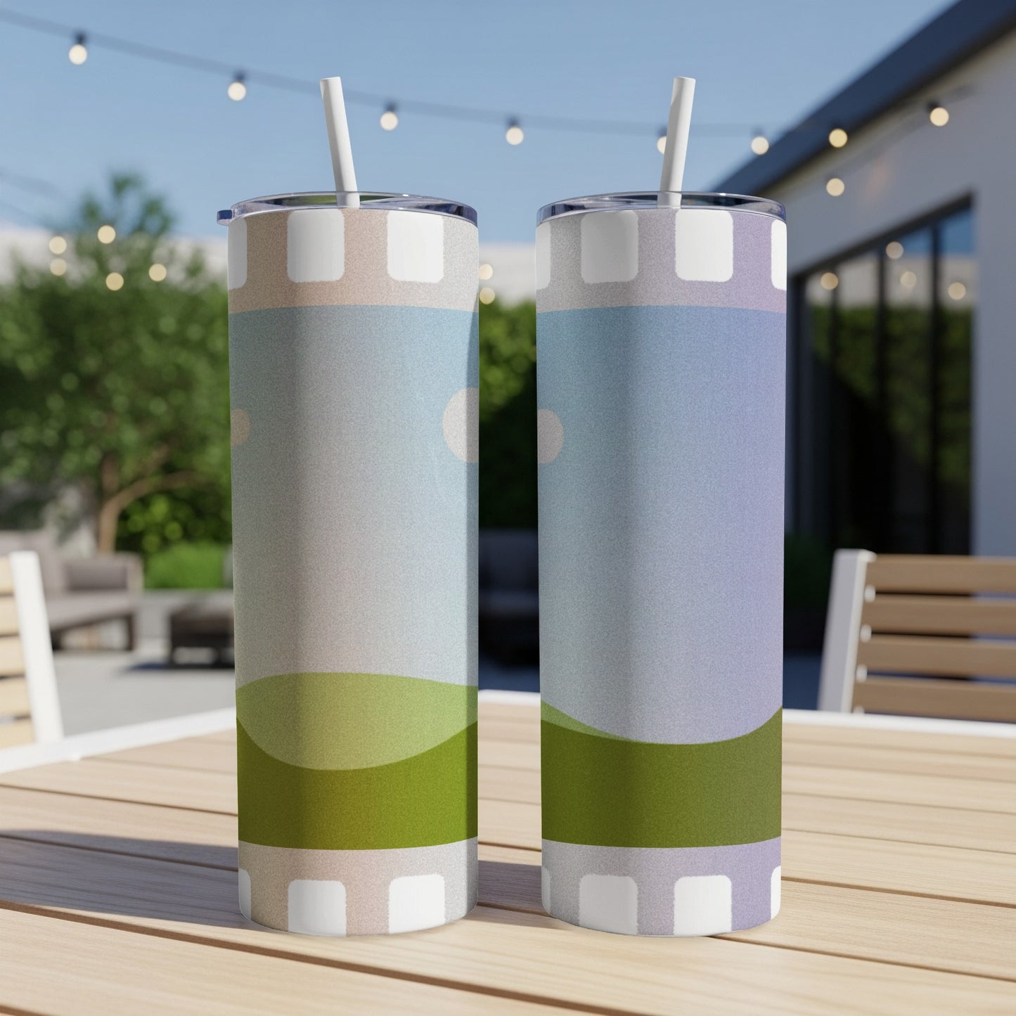 Two tumblers with abstract landscape design featuring green hills and blue sky.