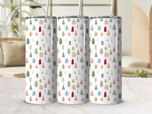 Three tumblers with a repeating pattern of colorful trees and snowflakes.