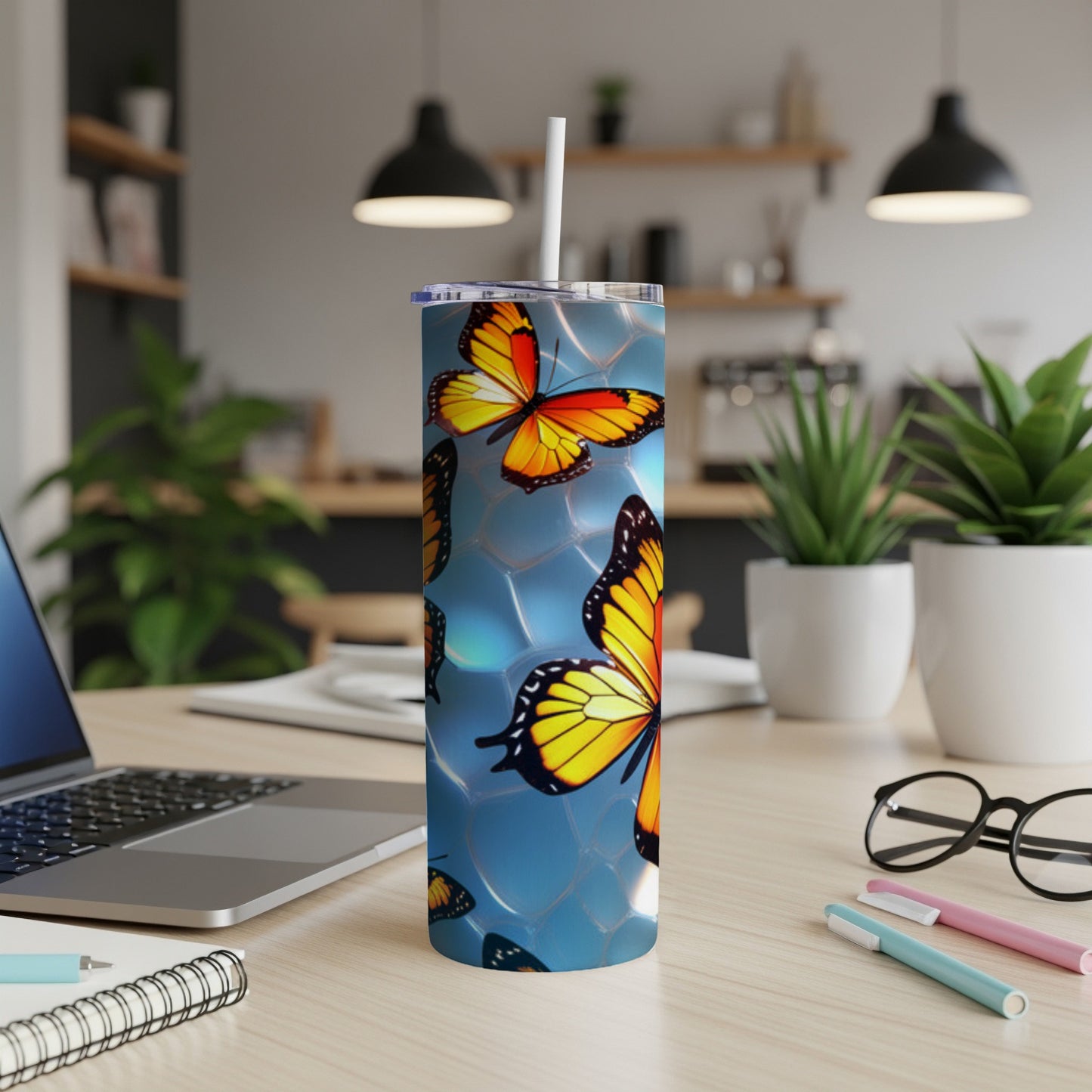 Tumbler with orange and yellow butterflies on a blue background.