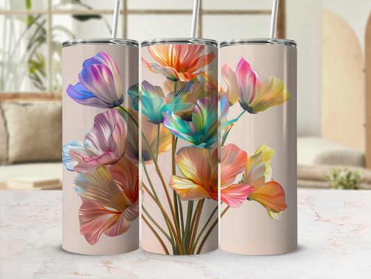 Three tumblers with colorful floral designs stand on a light-colored surface.