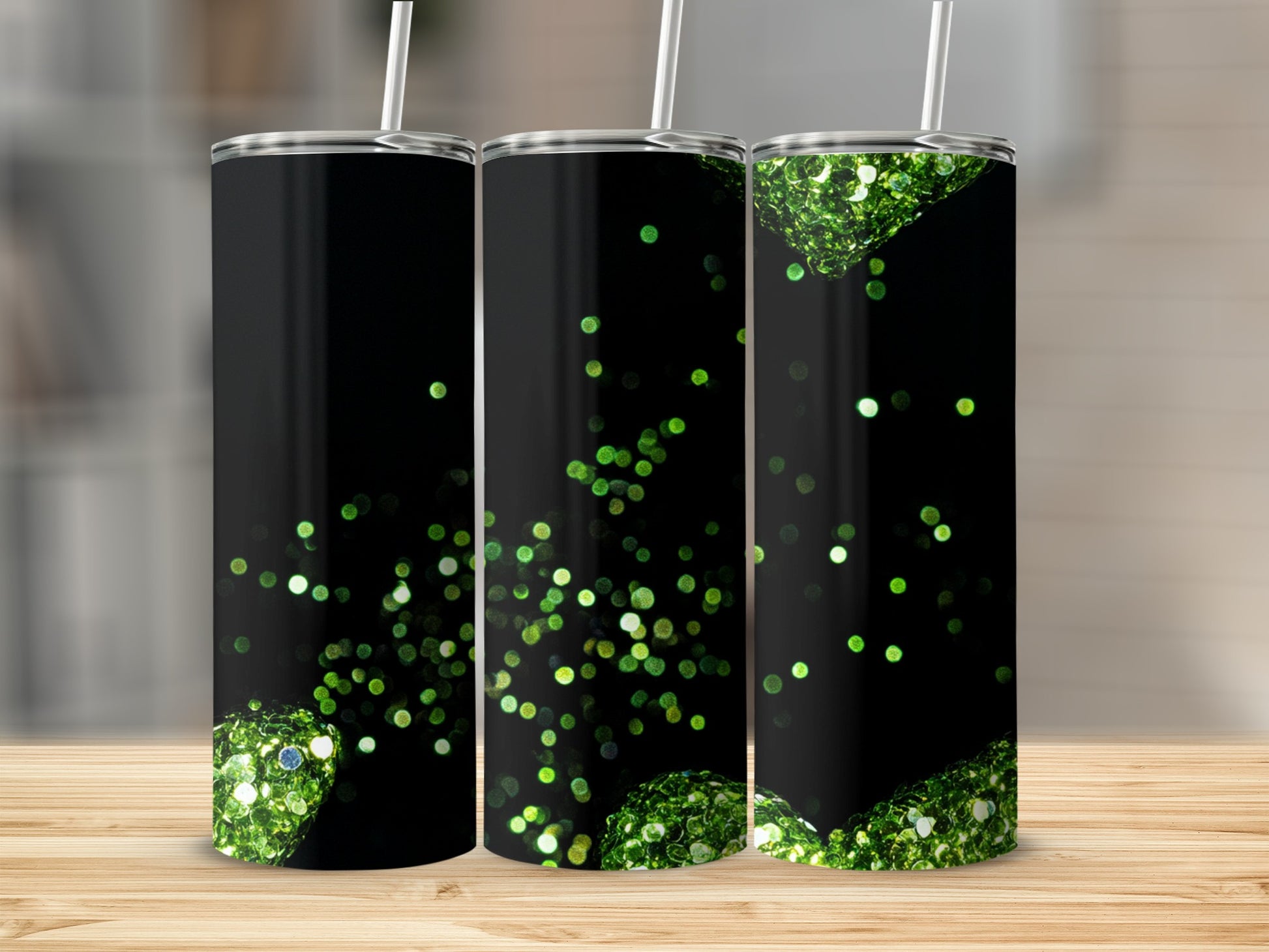 Black tumbler with scattered green glitter accents and straw.
