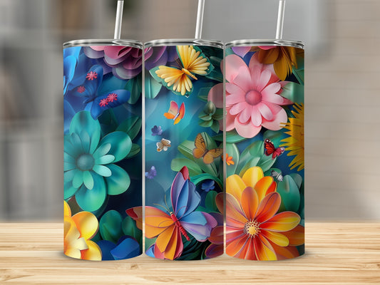 Three tumblers with vibrant floral and butterfly designs on a wooden surface.