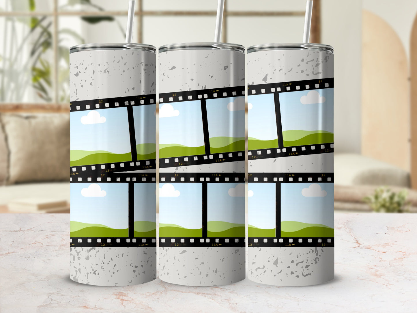 Three tumblers with film strip design and sky and rolling hills scenes.