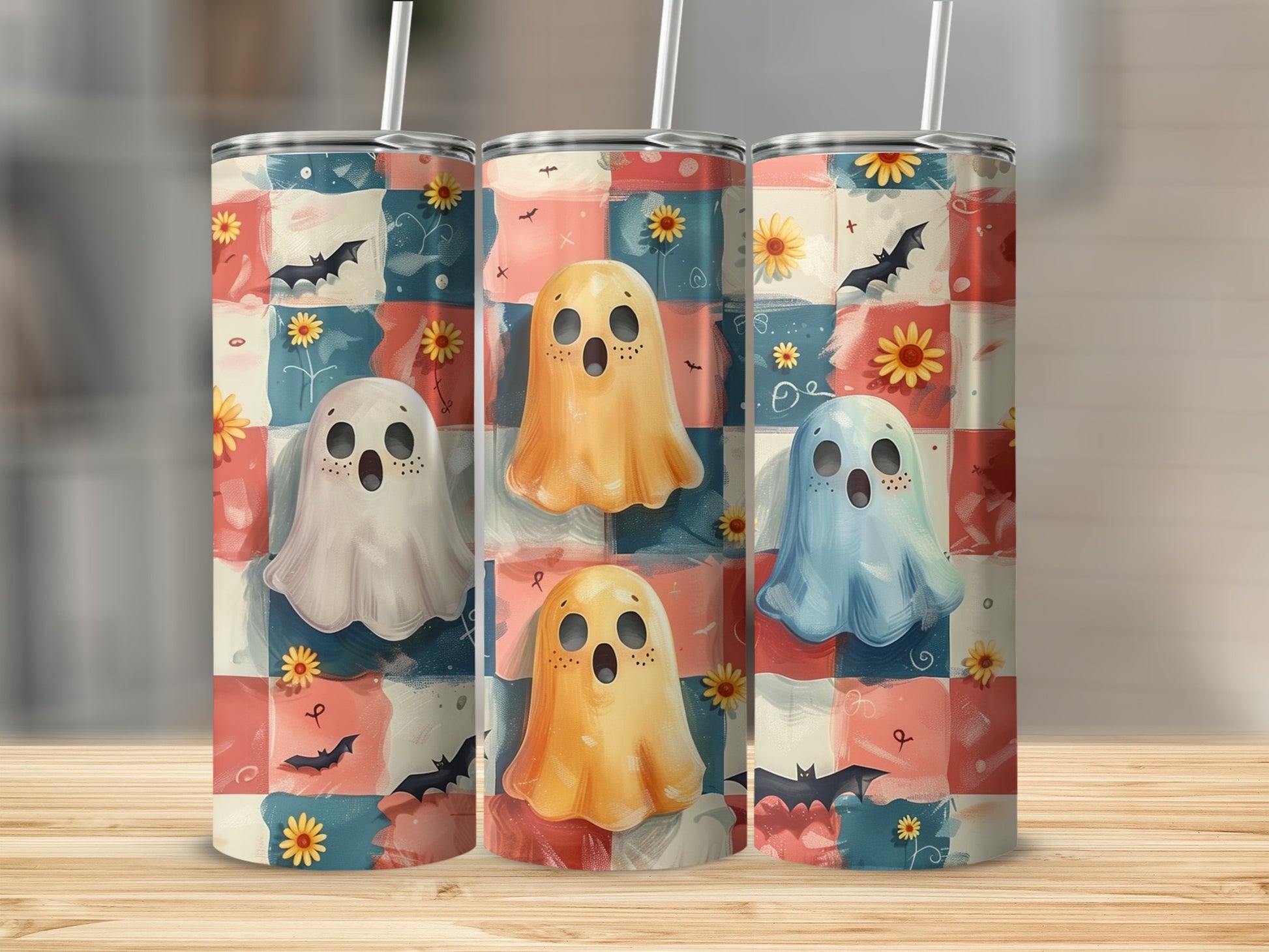 Three tumblers featuring playful ghosts, bats, and sunflowers on a checkered pattern.